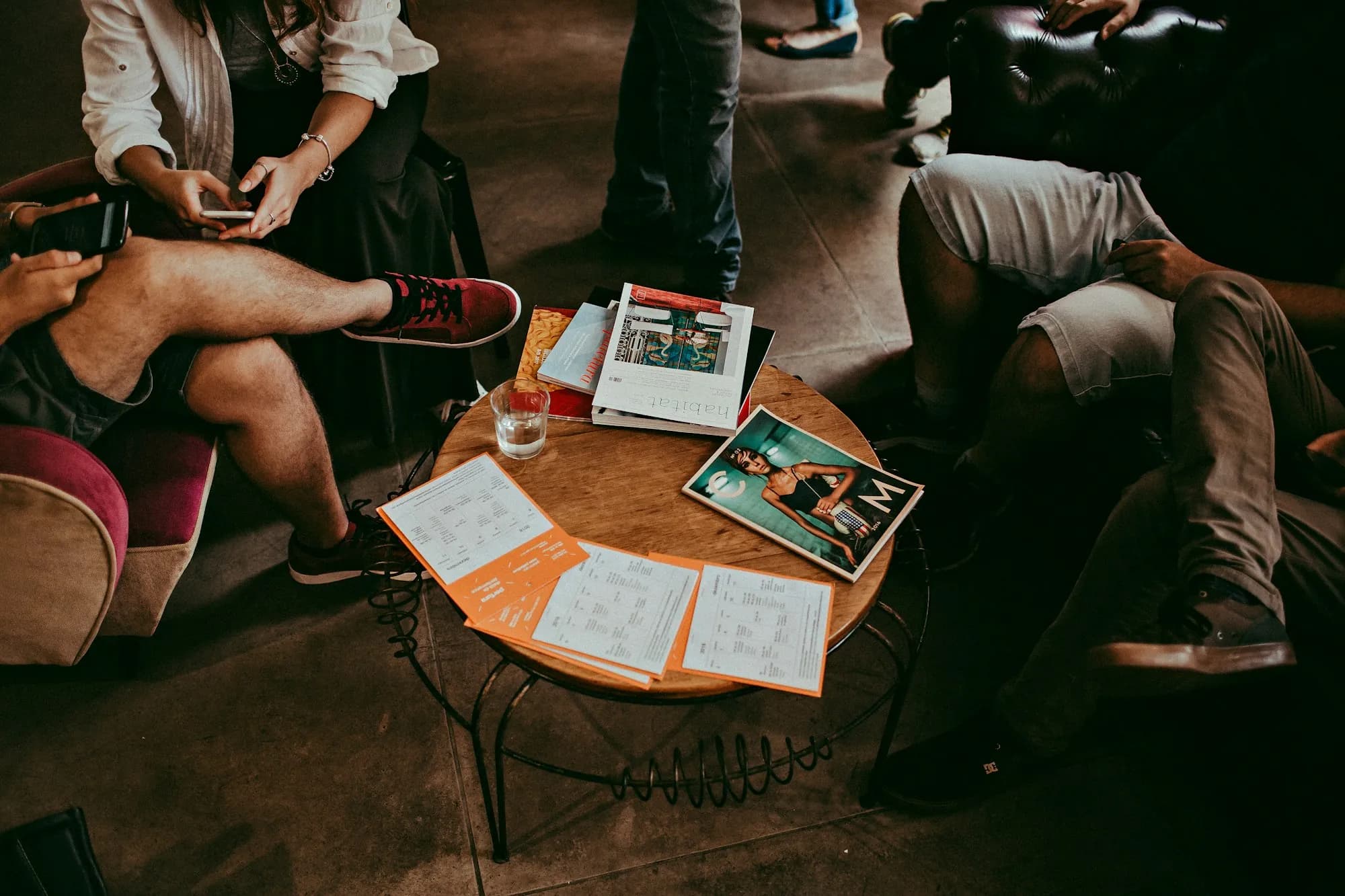 A small group sitting together around a low table